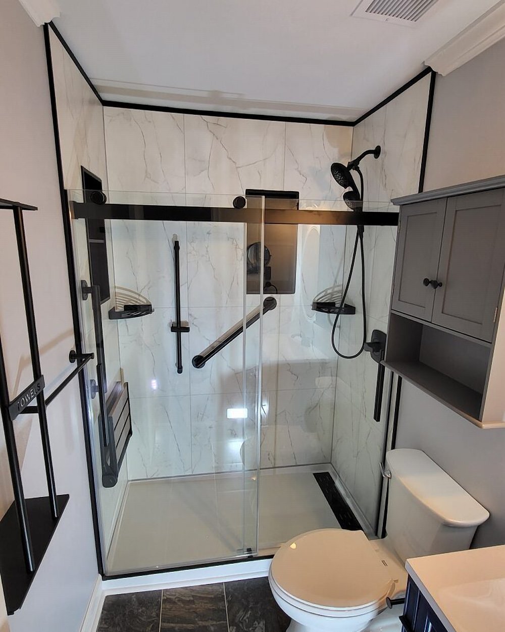 White oak and bianco marble shower install by Made New Home Solutions with matte black fixtures